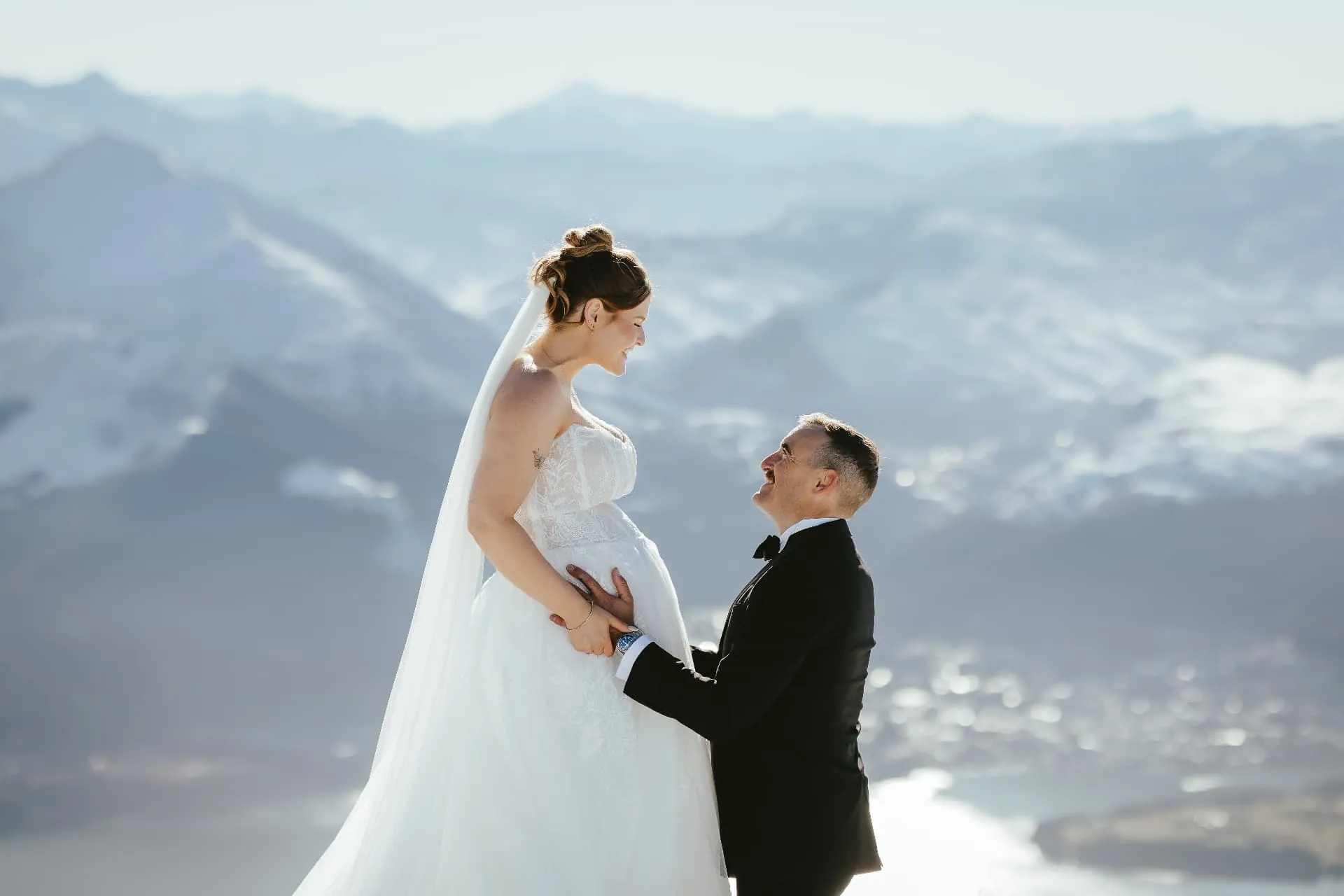 End of winter elopement on the Cecil Peak Spur, the couple in the snow with Lake Wakatipu below.