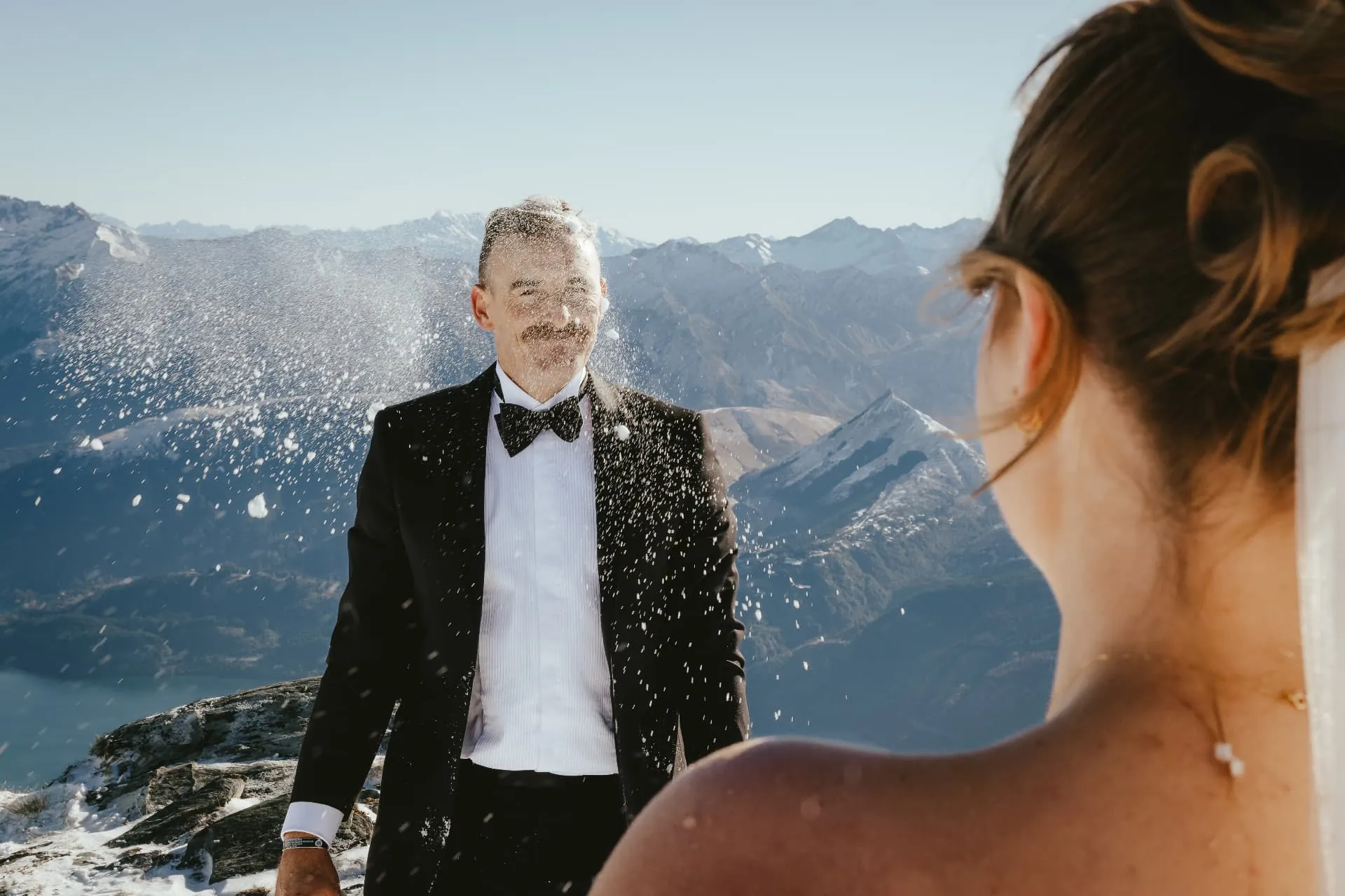Snow bursting around the groom with Lake Wakatipu below on the Cecil Peak Spur.