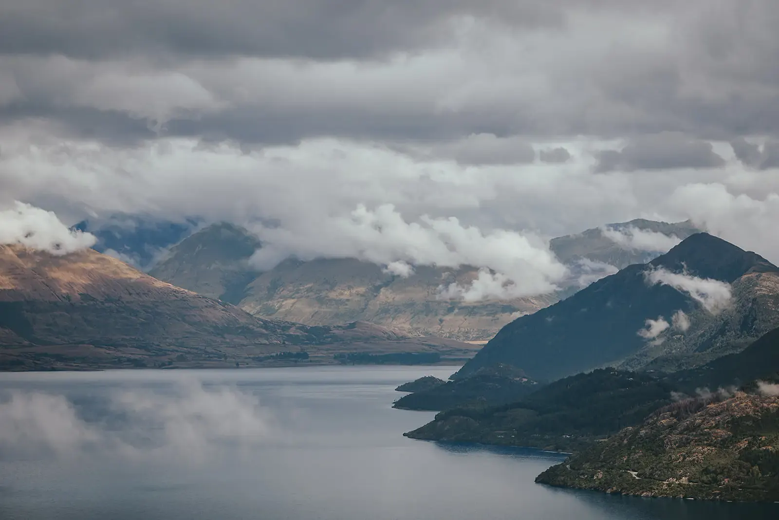 Light breaking through cloud over Lake Whakatipu and the mountains from Deer Park Heights