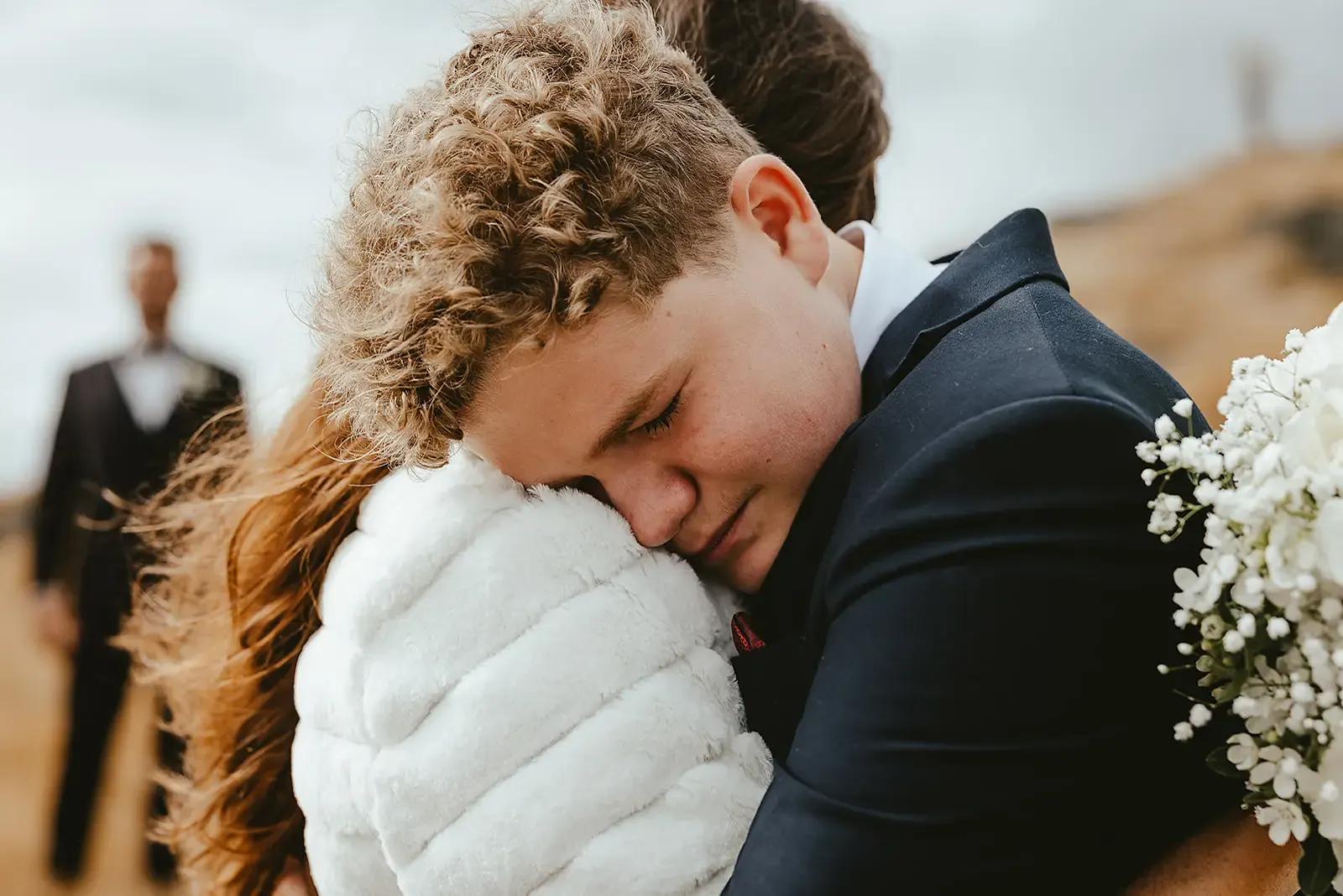 Emotional embrace between the bride and a young guest at Deer Park Heights
