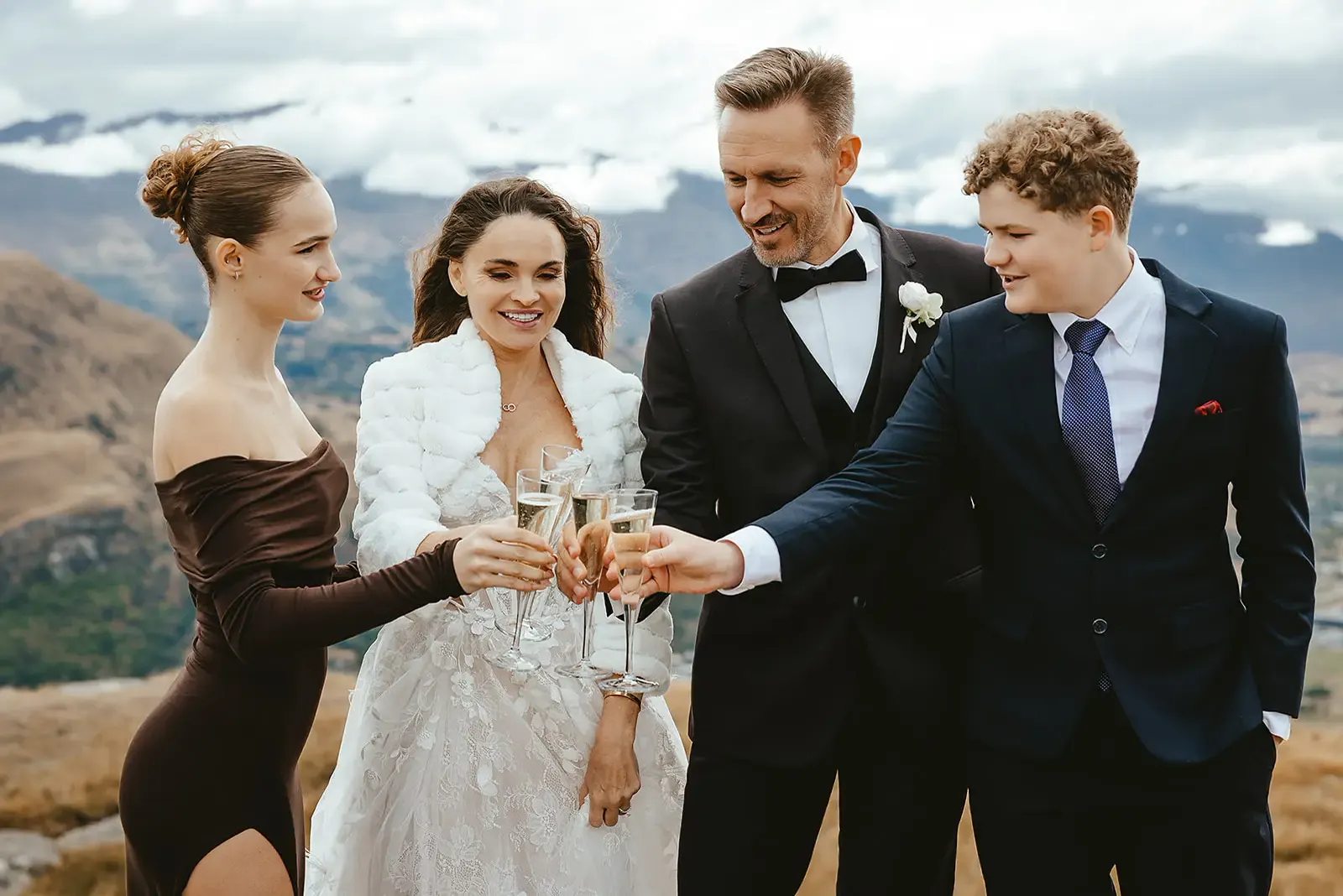 Family raising a champagne toast on the hilltop at Deer Park Heights
