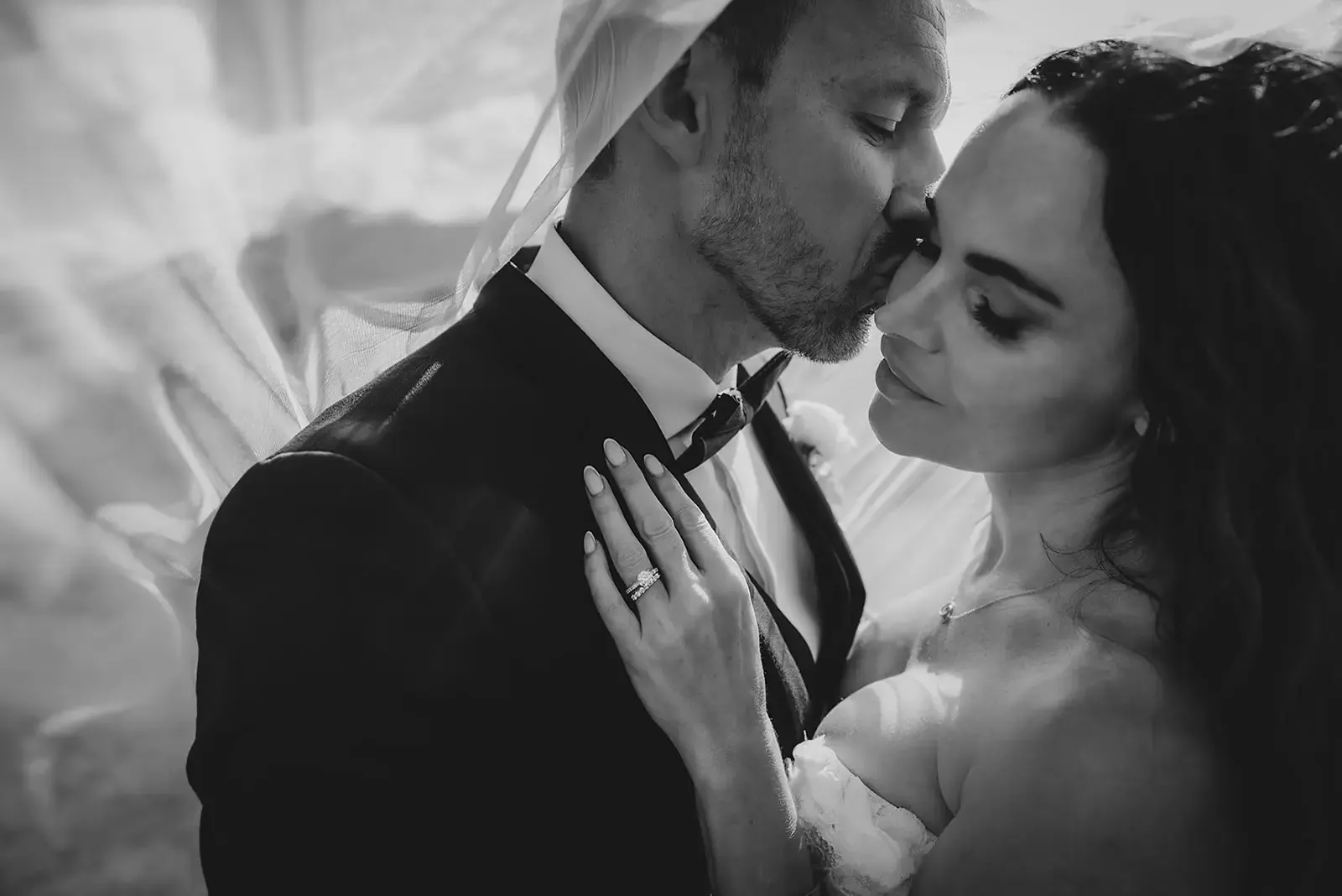 Black and white forehead kiss under the veil at Deer Park Heights