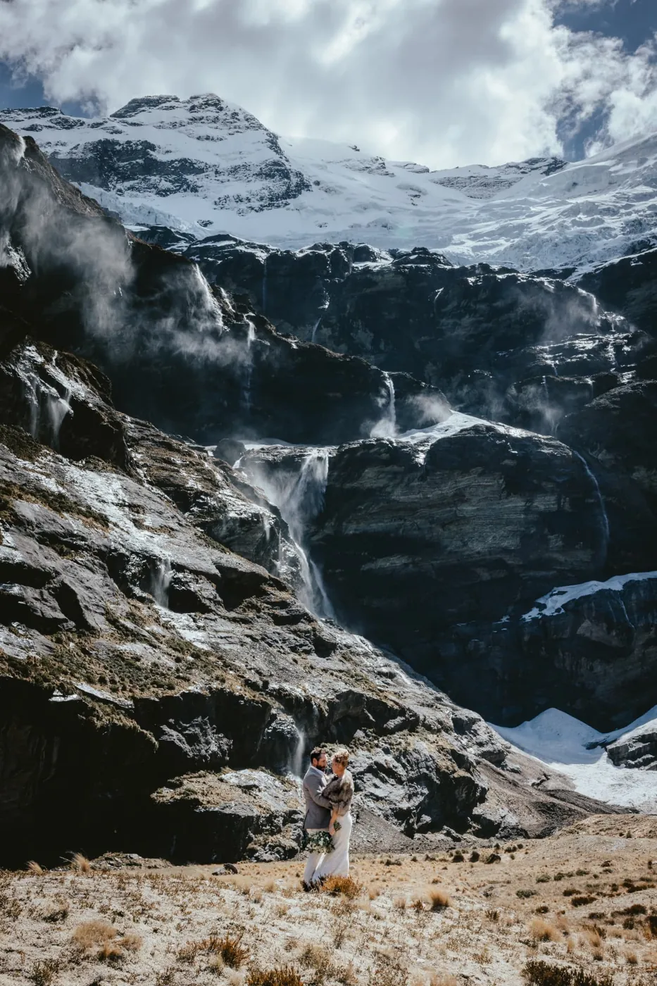 Bride and groom embracing in the Earnslaw Burn glacier basin north of Glenorchy, New Zealand.