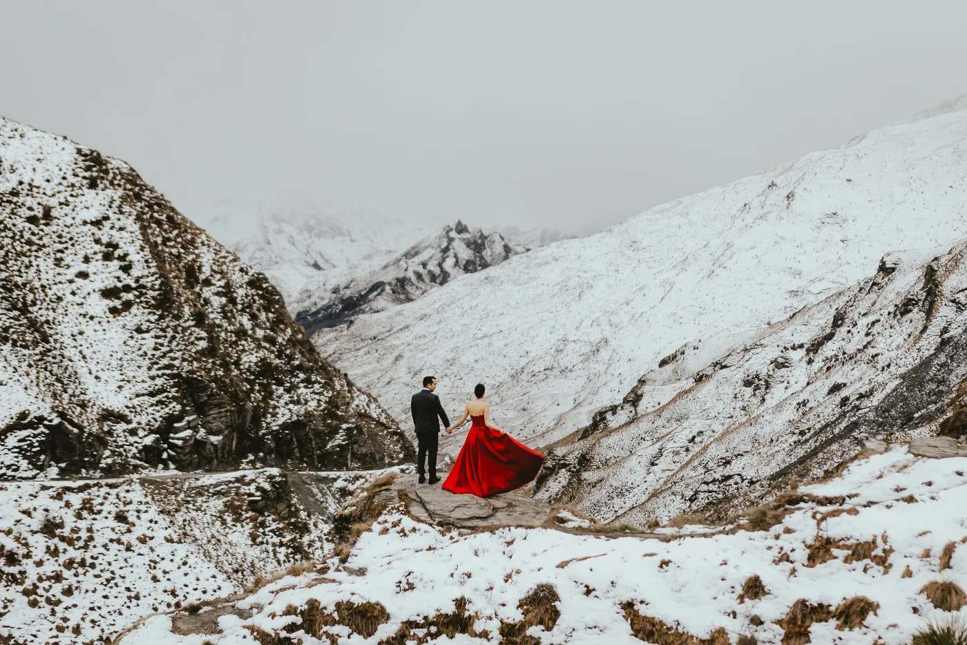 Couple embracing on a snowy alpine peak