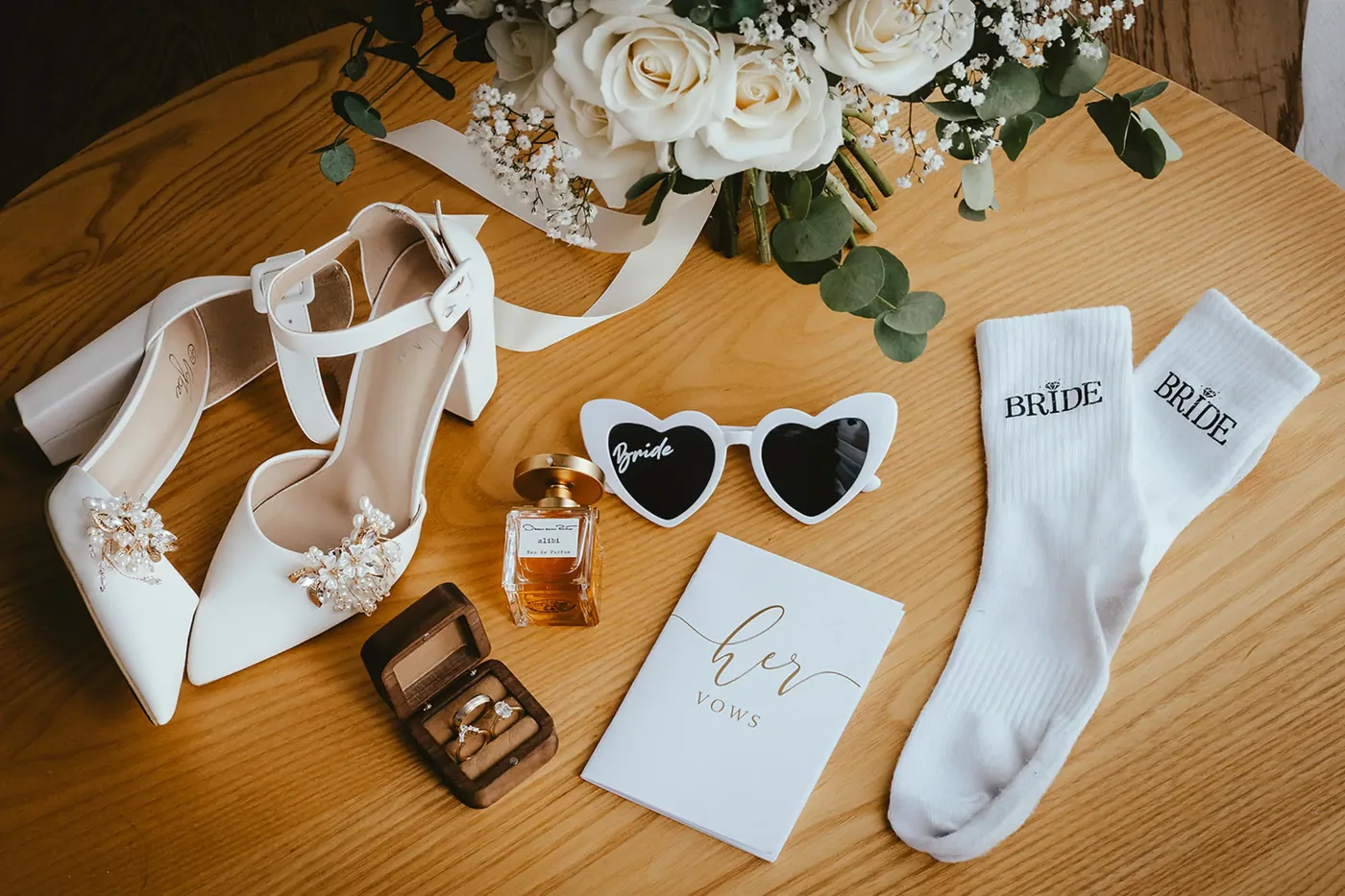 Bridal details: shoes, perfume, rings and vow book in Wanaka