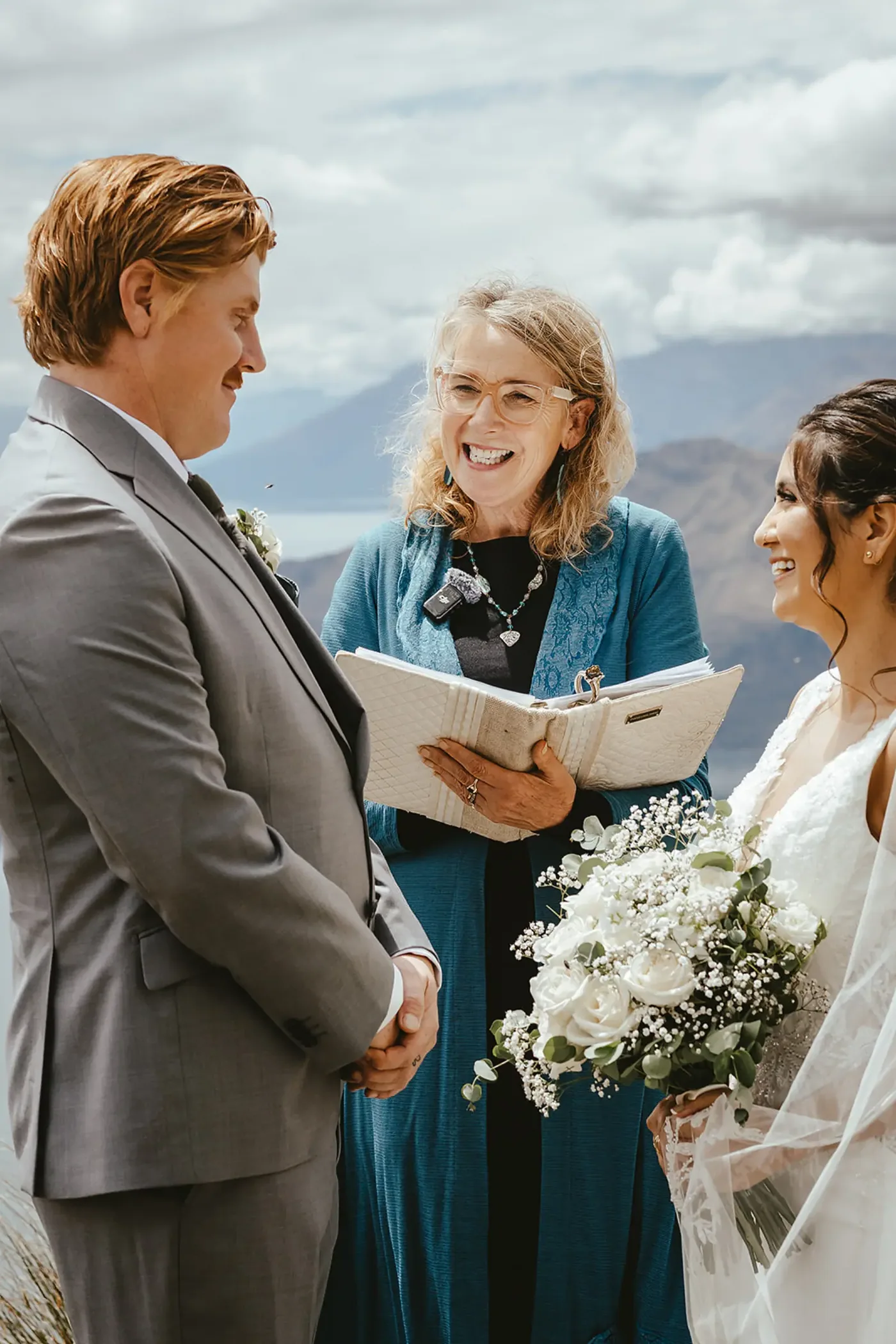 A couple exchanging vows with their celebrant on the summit of Coromandel Peak.